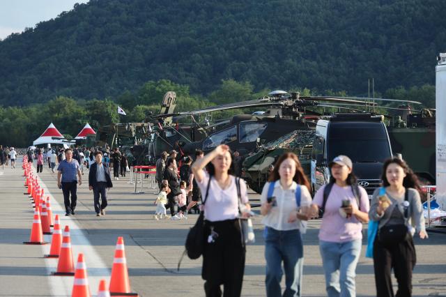 Visitors walk past military helicopters on display at the South Korean Army’s 2025 Ground Forces Festival in Gyeryong South Chungcheong Province Sept 18 2025 AJP Han Jun-gu