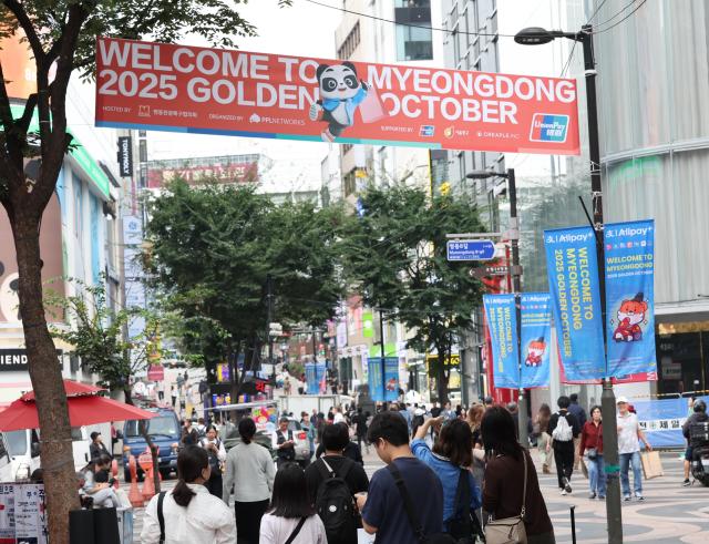 Tourists stroll at Seouls shopping district of Myeong-dong in the capital on Sept 30 2025 AJP