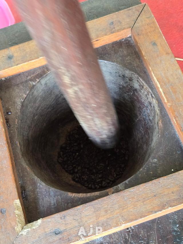 A tourist tries powdering coffee beans in a traditional Malaysian mortar and pestle set at Banguris Homestay in Sepang Selangor Sept 30 2025 AJP Kim Dong-young