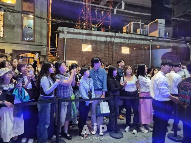 Visitors peer inside Entropys store mid performance AJP Candice Kim
