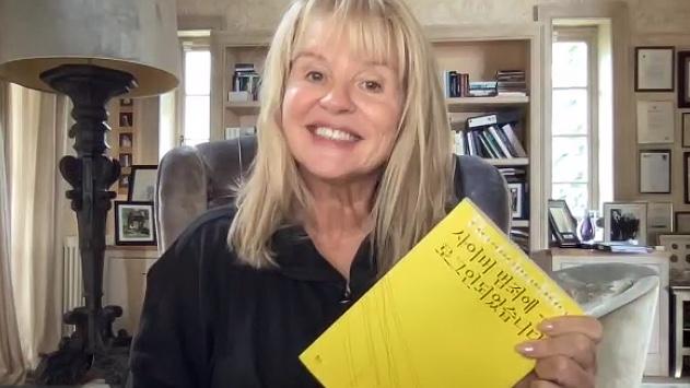 Irish psychologist Mary Aiken poses with her book during an interview via Zoom on Sept 29 2025 AJP Im Yoon-seo