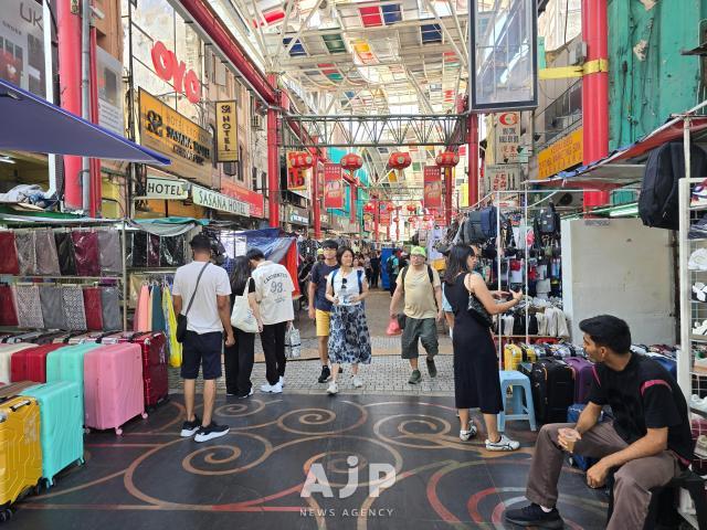 Tourists shop for gifts at the Chinese street vending markets of Petaling Street Market in Kuala Lumpur Oct 2 2025 AJP Kim Dong-young