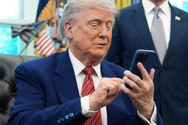 This file image shows President Donald Trump silencing his mobile phone in the Oval Office of the White House on May 23 2025 in WashingtonAPYONHAP