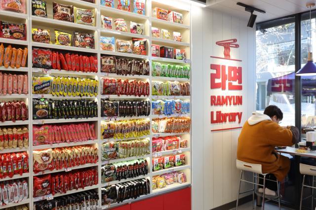 A foreign tourist tries Korean instant noodles at the Ramyun Library near Hongik University on Feb 19 2025 AJP Han Jun-gu