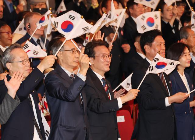 김민석 국무총리가 9일 서울 종로구 세종문화회관에서 열린 579돌 한글날 경축식에서 만세삼창을 한 뒤 태극기를 흔들고 있다 사진연합뉴스