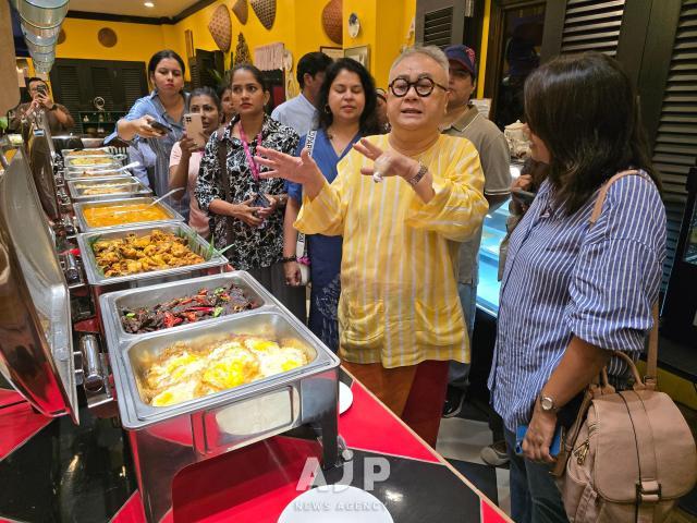 Chef Dato Ismail Ahmad explains to visitors how Malaysian people eat breakfast at Restoran Rebung Chef Ismail in Kuala Lumpur Oct 3 2025 AJP Kim Dong-young