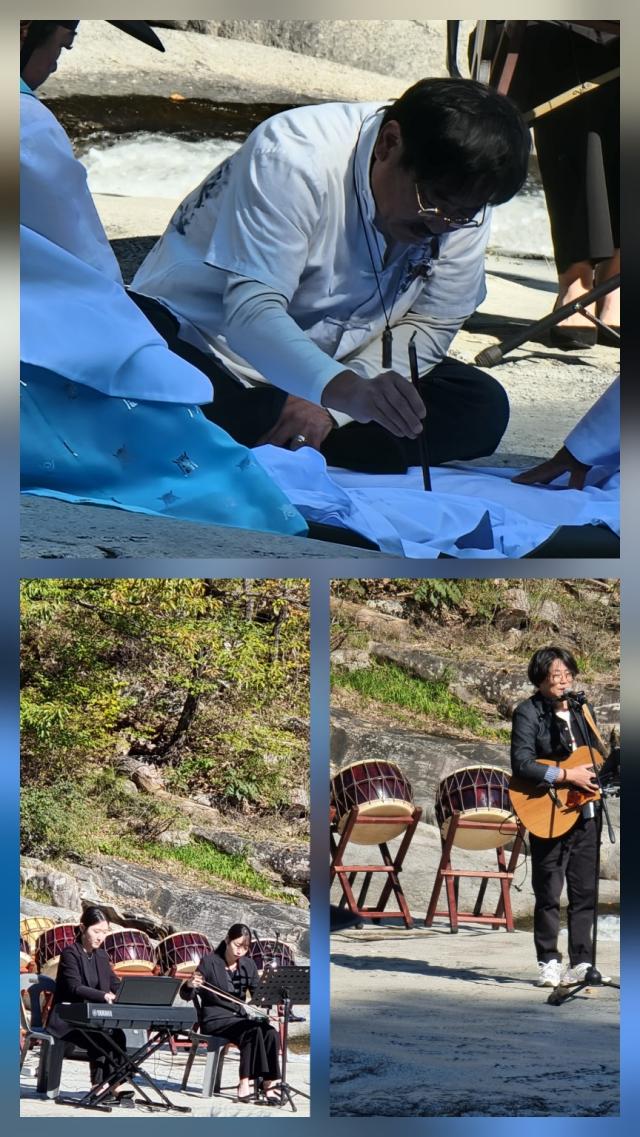 유현병 화백이 하얀 치마폭에 국화꽃 그림과 함께 좋은 글귀를 적어내려 가고 있다 사진이동원 기자