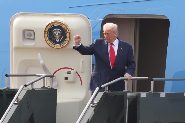 US President Donald Trump waves before boarding Air Force One at Gimhae International Airport in Busan on October 30 after concluding a summit with Chinese President Xi Jinping YONHAP