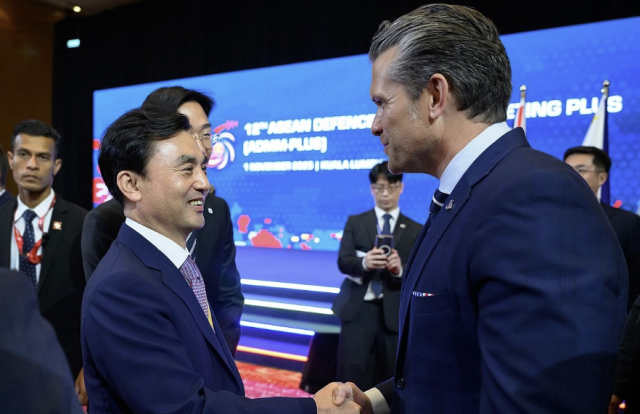 South Korean Defense Minister Ahn Kyu-baek shakes hands with US Defense Secretary Pete Hegseth in Kuala Lumpur Malaysia on Nov 1 2025 Yonhap