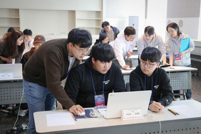 행복AI코딩챌린지의 비전챌린지에 참가한 청소년들이 경기 시작 전 인솔교사와 최종 준비사항을 확인하고 있는 모습