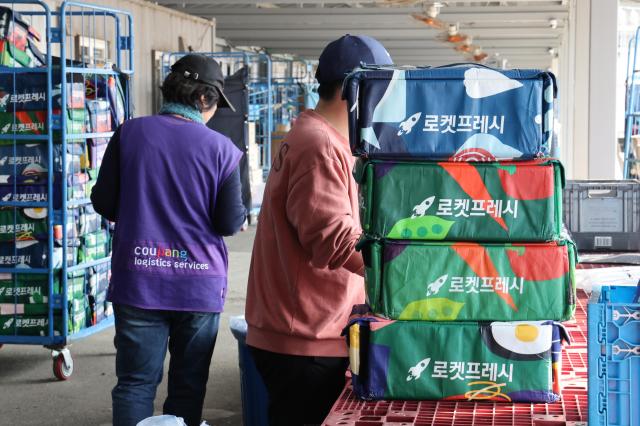 Workers in a Coupang logistics center in Seoul Nov 5 2025 Yonhap