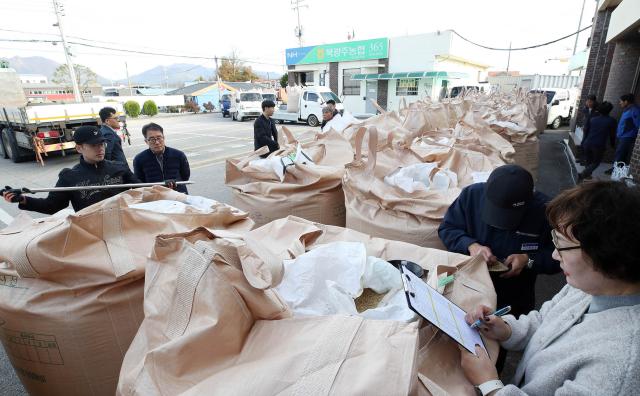 11일 오전 광주 북구 건국동 북광주농협 우치동지점에서 북구청 직원들이 올해 수확한 벼의 품질을 살펴보고 있다 