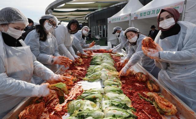 17일 서울 송파구 가락몰에서 열린 2025 가락시장 김장나눔 시민대축제에서 외국인 참가자들이 만든 김치를 들어보이고 있다 AJP Yoo Na-hyun