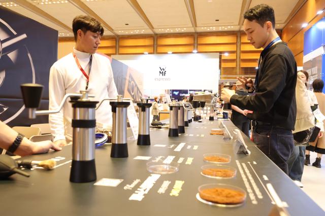 A visitor tries a coffee grinder at Cafe Show 2025 held at COEX in southern Seoul Nov 20 2025 AJP Han Jun-gu