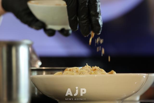Chef Fabri sprinkles pine nuts over pasta at the Italian Promotion Center in Gangnam District Seoul on Nov 14 2025 AJP Yoo Na-hyun