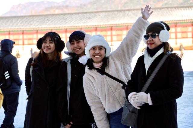 2025년 12월 5일 서울 종로의 광화문에서 관광객들이 첫눈을 즐기고있다