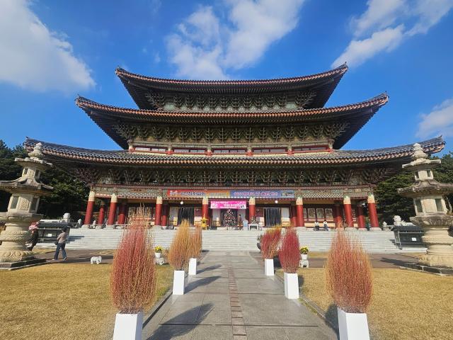 Tourists stroll through Yakcheonsa Temple in Seogwipo Jeju on Dec 7 2025 Yonhap