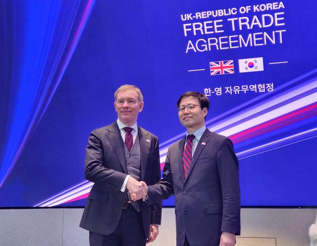 South Korean and British trade ministers Yeo Han-koo and Chris Bryant pose for a photo after modernizing bilateral FTA after two-year negotiations in London on Dec 15 2025 Yonhap