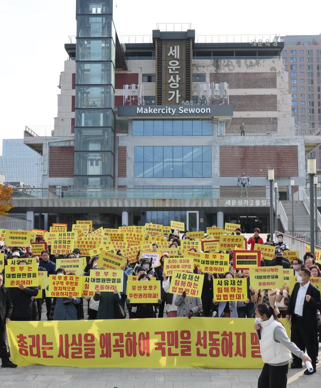 국가유산청이 유네스코 세계유산인 종묘 인근 세운4구역 재개발 사업에 문제를 제기한 데 대해 이 일대 토지주들이 11일 서울 종로구 다시세운광장 앞에서 기자회견을 마친 뒤 구호를 외치고 있다 20251111 사진연합뉴스