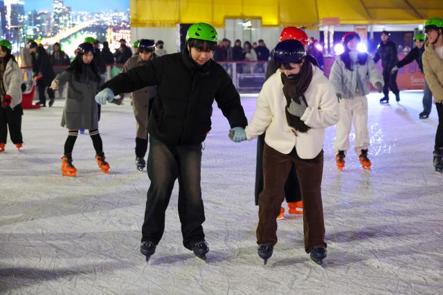 Visitors skate at the Seoul Plaza Ice Rink in Jung-gu central Seoul on Dec 19 AJP Yoo Na-hyun
