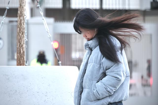 A person heavily dressed walks Gwanghwamun Square in Seoul Dec 26 2025 AJP Han Jun-gu