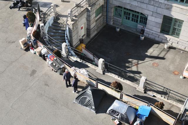 Piles of belongings and tents used by homeless people are spread out outside Seoul Station Dec 26 2025