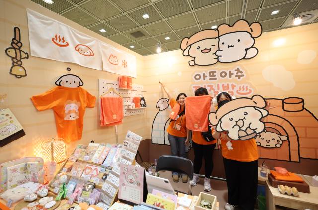 Booth staff pose at an illustration fair held at COEX in Gangnam Seoul on Dec 26 2025 AJP Han Jun-gu
