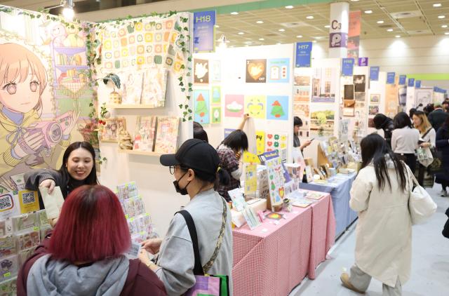 Visitors browse booths at an illustration fair held at COEX in Gangnam Seoul on Dec 26 2025 AJP Han Jun-gu