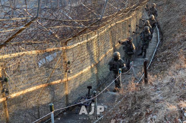 Soldiers of the Army’s 5th Infantry Division patrol along the barbed-wire fence with a quadrupedal robot under trial deployment near the inter-Korean border AJP Yoo Na-hyun