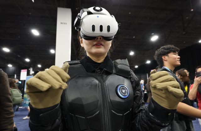 On Jan 5 local time a visitor wearing a suit and a VR headset experiences virtual reality at CES 2026 Unveiled held at the Mandalay Bay Convention Center in Nevada ahead of the world’s largest consumer electronics and information technology exhibition CES 2026 Yonhap