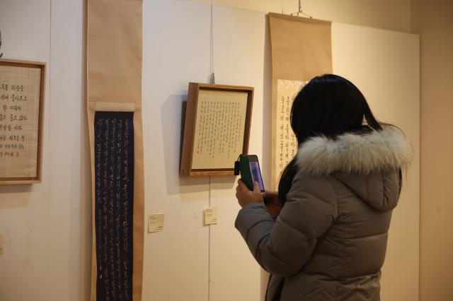 A visitor photographs exhibits at Bukchon Hanok Office in Jongno-gu Seoul Dec 30 AJP Han Jun-gu
