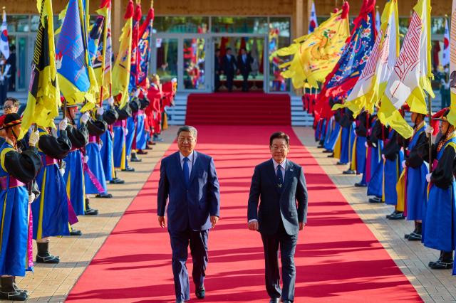 President Lee Jae Myung and Chinese President Xi Jinping move to the summit venue prepared at the Special Exhibition Hall of the Gyeongju National Museum in North Gyeongsang Province for their summit meeting on Nov 1 2025 Yonhap