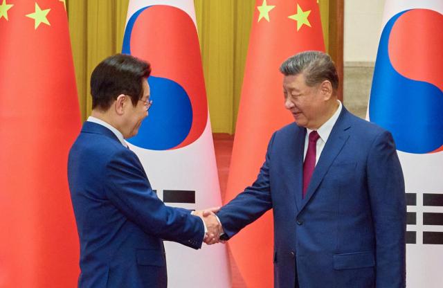 Lee Jae-myung shakes hands with Xi Jinping during a welcome ceremony at the Great Hall of the People in Beijing during Lee’s state visit to China on Jan 5 2026