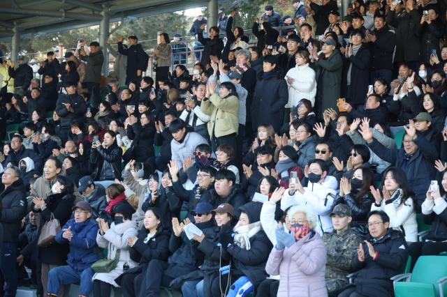 Family members and friends cheer for new recruits at the first military enlistment ceremony of 2026 held at the Army Training Center in Nonsan South Chungcheong Province Jan 5 2026 Yonhap
