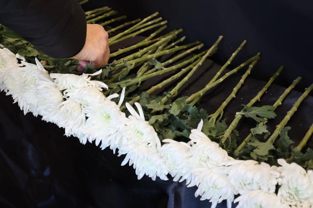 A citizen lays flowers at the memorial space for the late actor Ahn Sung-ki at the Seoul Cinema Center in Jung-gu Seoul Jan 7 2026 AJP Han Jun-gu