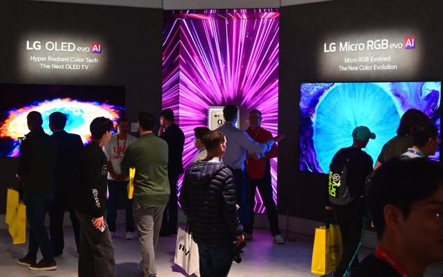 Visitors crowd LG Electronics’ booth in Las Vegas checking out the company’s 2026 TV lineup including the LG OLED evo AI W6 and the premium LCD model LG Micro RGB evo 