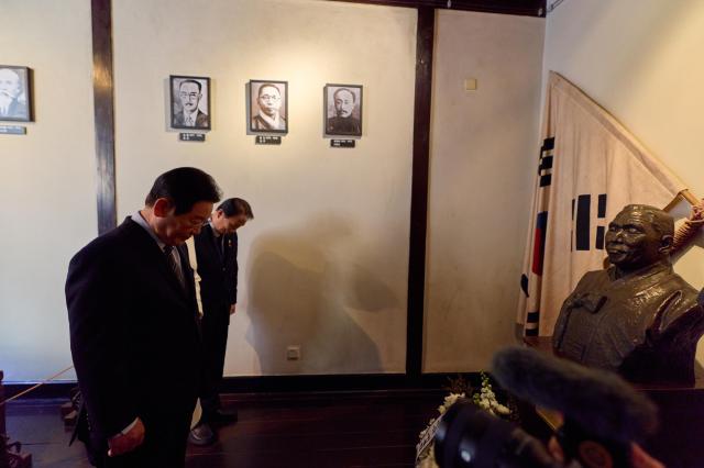 President Lee Jae-myung and Kwon Oh-eul minister of Patriots and Veterans Affairs observe a moment of silence after laying flowers at the bust of independence leader Kim Gu during their visit to the Provisional Government of the Republic of Korea historic site in Shanghai China Jan 7 2026 Yonhap