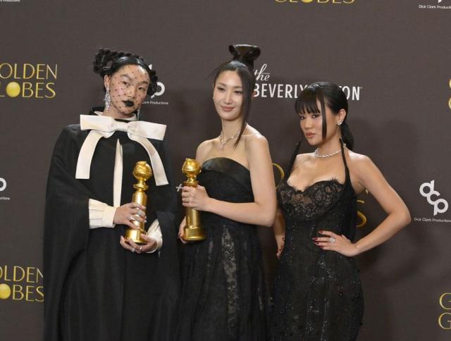 American singer and rapper Audrey Nuna far left South Korean-American singer-songwriter Ejae center and South Korean singer and rapper Rei Ami pose for a photo after winning an award at the annual Golden Globes in Beverly Hills California on Jan 11 2026 UPI-Yonhap