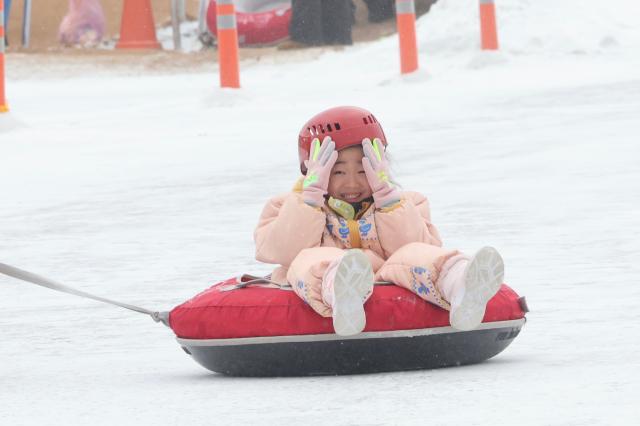 A child rides a snow tube at the Hwacheon Sancheoneo Ice Festival in Hwacheon Gangwon Province Jan 12 2026 AJP Han Jun-gu