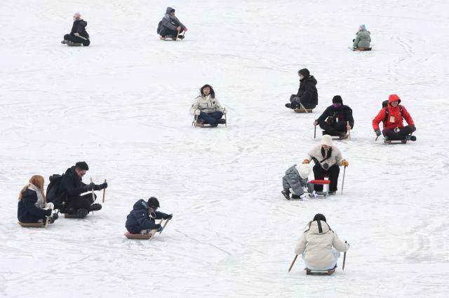 Visitors enjoy snow sled at the Hwacheon Sancheoneo Ice Festival in Hwacheon Gangwon Province Jan 12 2026 AJP Han Jun-gu