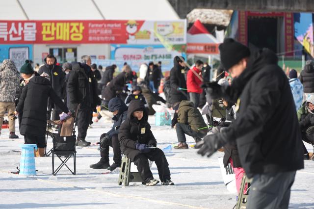 Visitors try ice fishing across the frozen ice field at the Hwacheon Sancheoneo Ice Festival in Hwacheon Gangwon Province Jan 12 2026 AJP Han Jun-gu