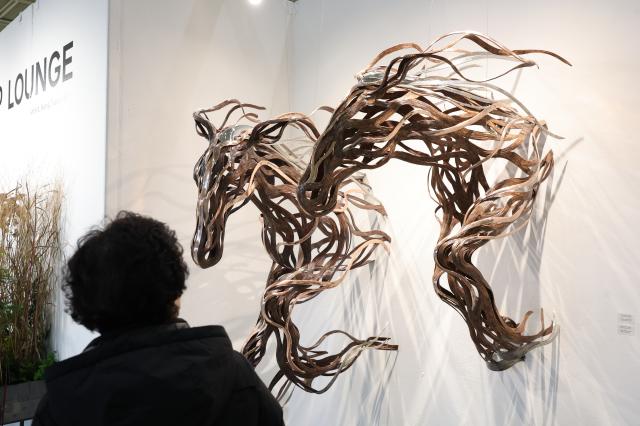 A visitor views sculptures at the Seoul International Sculpture Festa 2026 at COEX in Gangnam Seoul Jan 14 2026