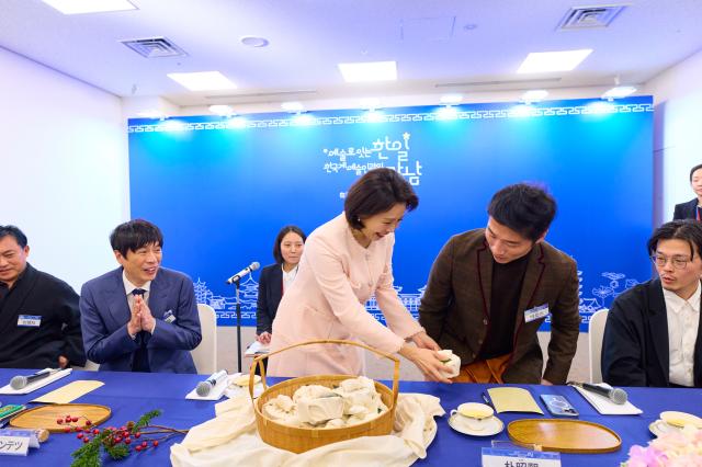 이재명 대통령과 함께 일본을 방문한 김혜경 여사가 13일 일본 나라컨벤션센터에서 열린 재일 한국계 예술인 간담회에서 한국에서 손수 준비한 다과를 나눠주고 있다 사진연합뉴스