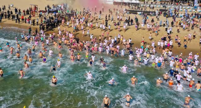 Participants dive into the winter sea during the Haeundae Polar Bear Festival at Haeundae Beach in Busan on Jan 18 2026 Yonhap