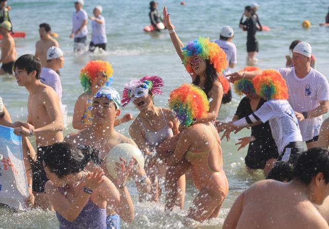 Participants dive into the winter sea during the Haeundae Polar Bear Festival at Haeundae Beach in Busan on Jan 18 2026 Yonhap