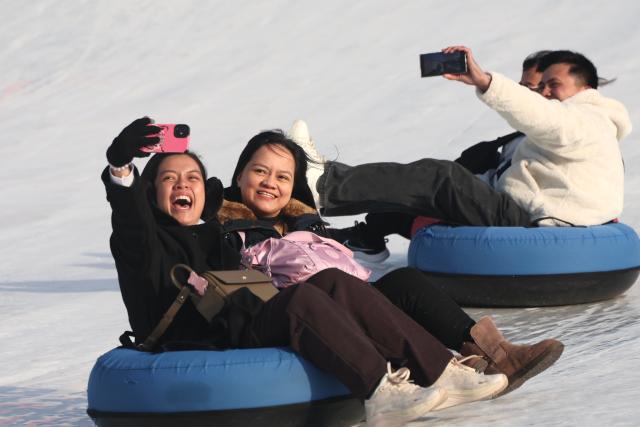 Visitors enjoy snow tubing at a snow sledding area in Ttukseom Seoul Jan 19 2026 AJP Han Jun-gu