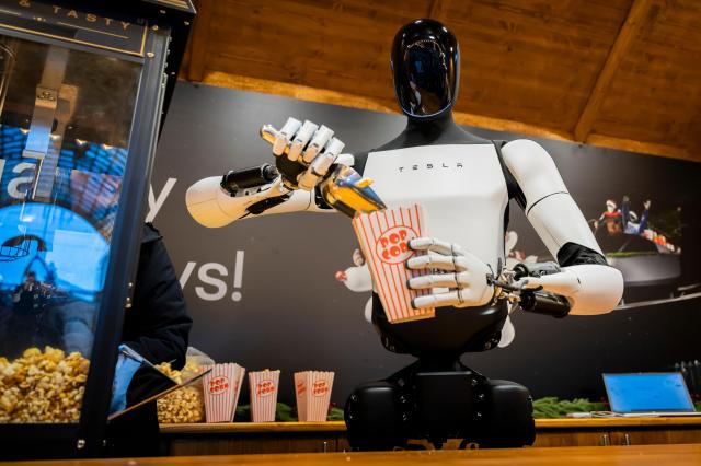 Tesla's humanoid Optimus serving popcorn in a presentation in Berlin, Germany, Dec. 20, 2025. AP-Yonhap