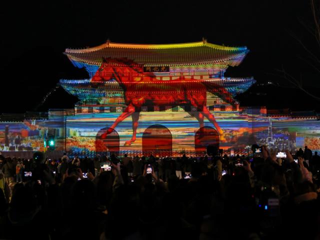 Visitors enjoy a media art show projected against the backdrop of Gwanghwamun Gate during the Seoul Winter Festa Dec 12 2025 AJP Yoo Na-hyun