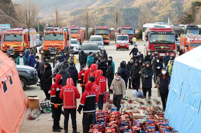 Fire officials prepare for firefighting operations at Okgok Middle School where the wildfire command center has been set up in Okgok-myeon Gwangyang South Jeolla Province on the morning of Jan 22 2026