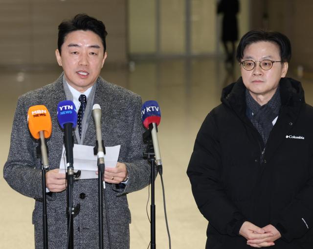 Presidential Chief of Staff Kang Hoon-sik speaks to reporters before departing for Canada through Incheon International Airport on January 26 2026 On the right is Minister of Trade Industry and Resources Kim Jung-kwan Yonhap 